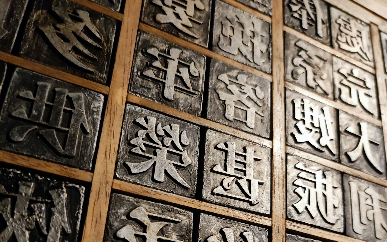 木製の棚に並ぶ漢字の金属活字——書体デザインとフォントの権利